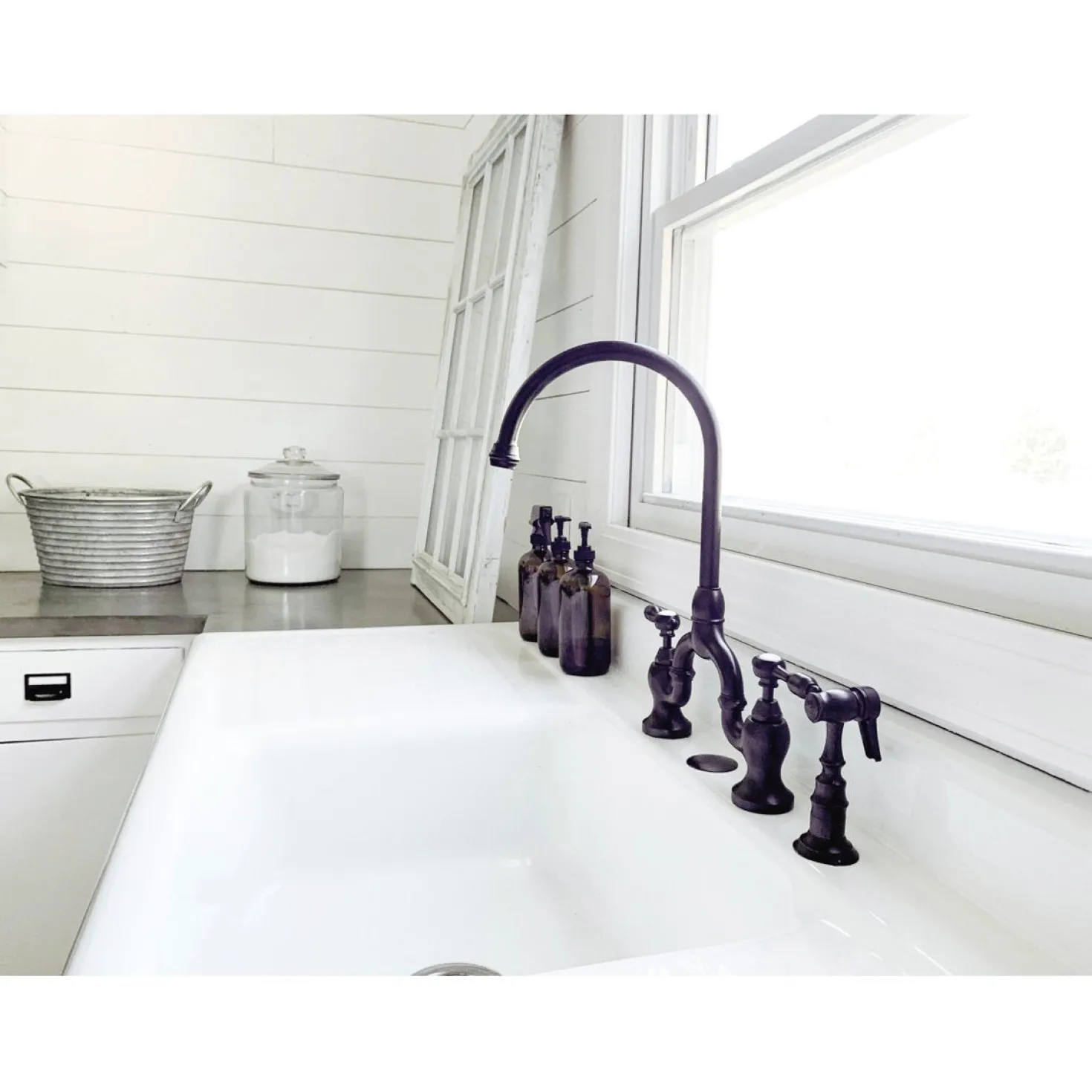 Kingston Brass Tudor Bridge Deck Mount Kitchen Faucet with Brass Sprayer