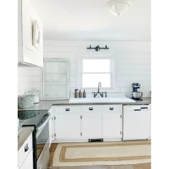 Kingston Brass Tudor Bridge Deck Mount Kitchen Faucet with Brass Sprayer