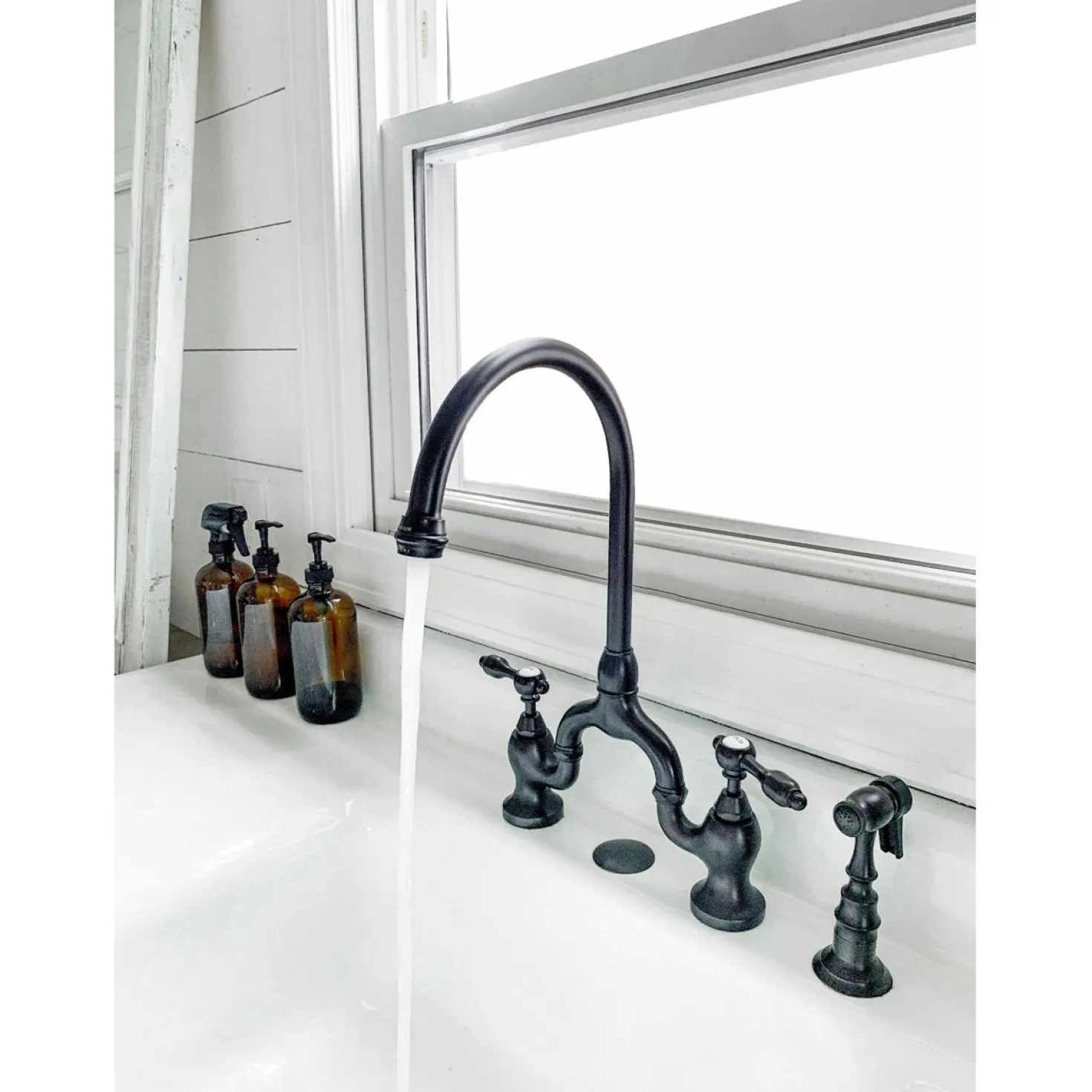 Kingston Brass Tudor Bridge Deck Mount Kitchen Faucet with Brass Sprayer